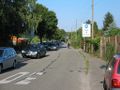 with motor vehicle, without kerb, gravel sidewalk left of the parking